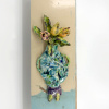 Wendy Limburg: Bloemen (2025), aardewerk op hout, 44 x 14 cm. 65 euro