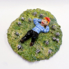 Jeannet Klement: Liggen in het gras tussen magische bollen, keramiek, 5 x 20 x 20 cm. 295 euro