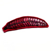 Marianne Aulman: Broche veer, mixed media, 3 x 8 cm. 35 euro